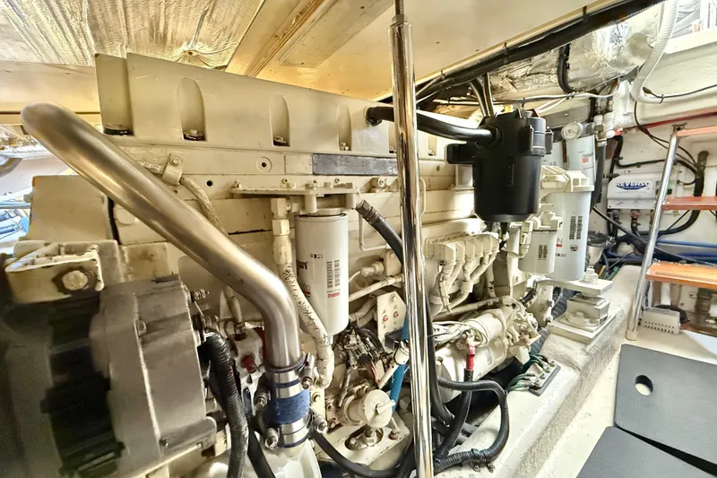 Slide: The Image of Engine room of 2001 Riviera 40 Flybridge yacht, showcasing mechanical components and systems. - 66