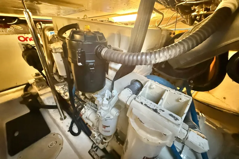 Slide: The Image of Engine room of 2001 Riviera 40 Flybridge yacht, showcasing mechanical components and systems. - 68