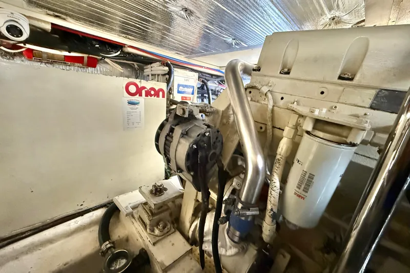 Slide: The Image of Engine room of a 2001 Riviera 40 Flybridge yacht, featuring Onan generator and components. - 72