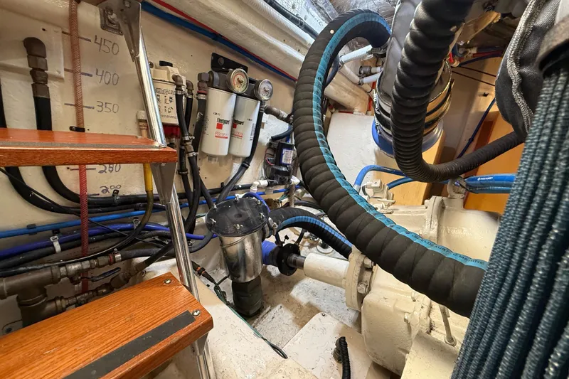 Slide: The Image of Engine room of 2001 Riviera 40 Flybridge with visible hoses and equipment. - 75