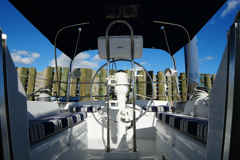 Slide: The Image of Cockpit of 1983 Hunter 34 sailboat with striped seating and steering wheel. - 12