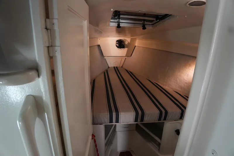 Slide: The Image of Cozy cabin interior of 1983 Hunter 34 sailboat with striped bedding. - 14