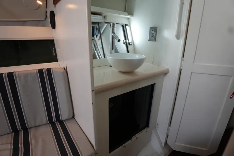 Slide: The Image of Interior of 1983 Hunter 34 sailboat with striped seating and countertop bowl. - 16