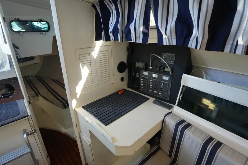 Slide: The Image of Interior of 1983 Hunter 34 sailboat with navigation station and striped upholstery. - 20