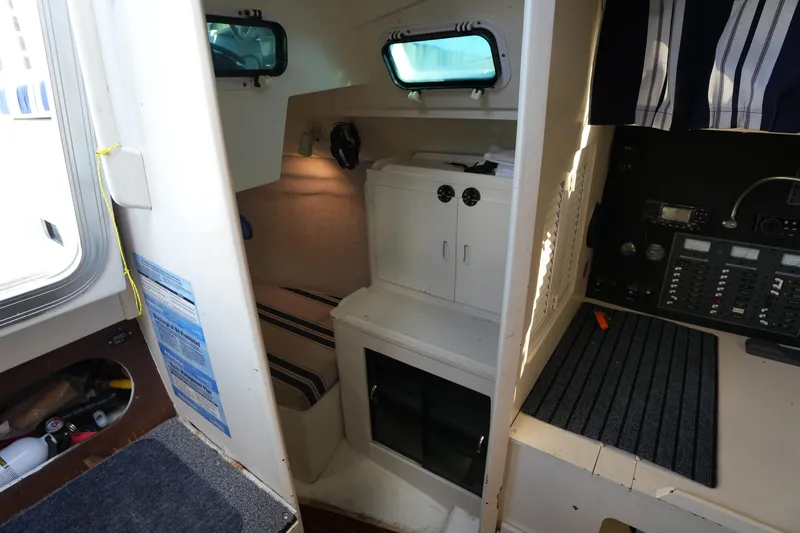 Slide: The Image of Interior of a 1983 Hunter 34 sailboat featuring a cozy cabin and navigation equipment. - 23