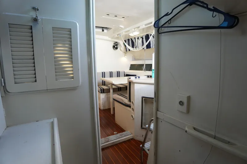 Slide: The Image of Interior of 1983 Hunter 34 sailboat with cozy dining area and wooden flooring. - 25