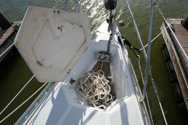 Slide: The Image of Bow of 1983 Hunter 34 sailboat with anchor chain and rope in marina. - 7