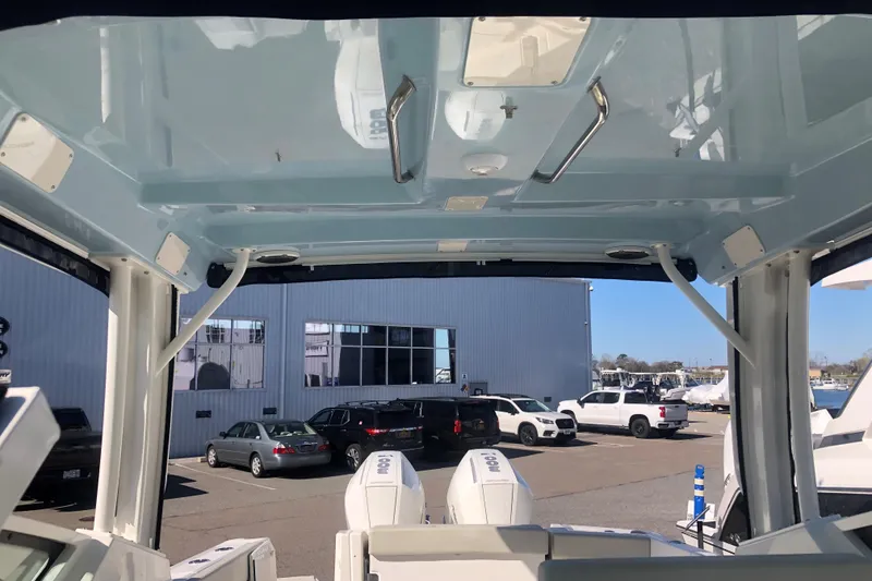 Slide: The Image of 2024 Boston Whaler 280 Vantage interior view with visible roof and outdoor setting. - 12