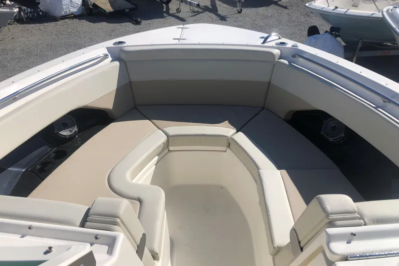 Slide: The Image of 2024 Boston Whaler 280 Vantage boat interior with spacious seating and cup holders. - 13