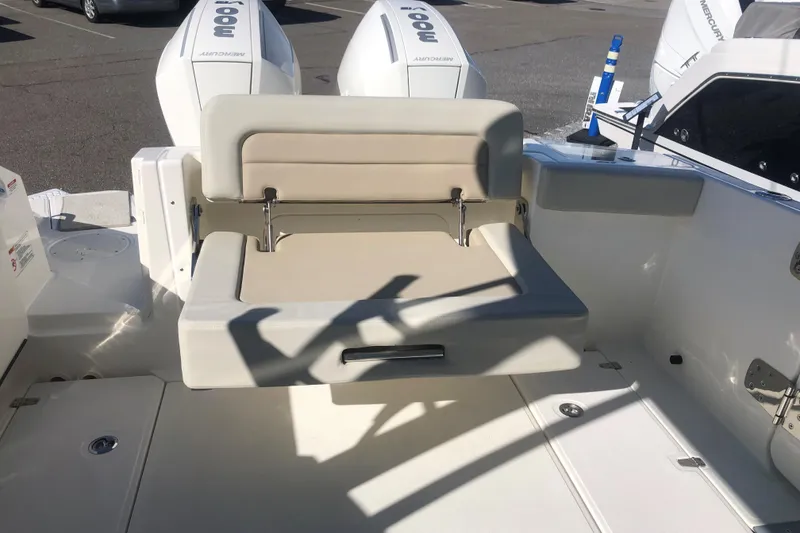 Slide: The Image of 2024 Boston Whaler 280 Vantage boat seating area with dual Mercury engines. - 2