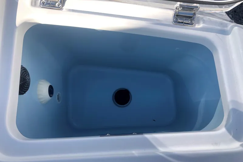 Slide: The Image of Livewell compartment in 2024 Boston Whaler 280 Vantage boat, open lid view. - 3