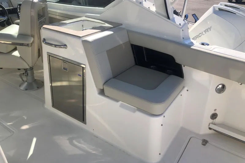Slide: The Image of 2024 Boston Whaler 280 Vantage interior with seating and stainless steel storage. - 4