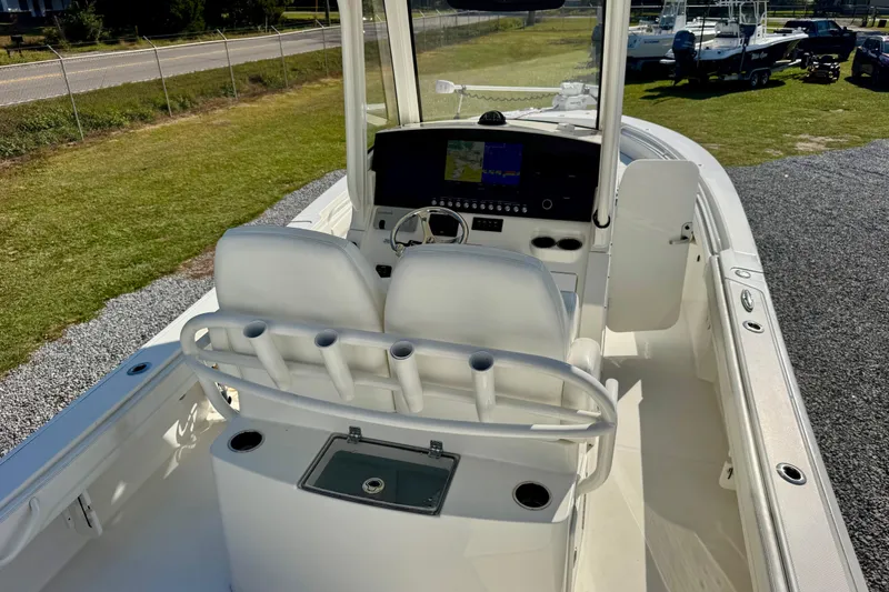 Slide: The Image of 2021 Regulator 26XO boat interior with helm, seating, and navigation display. - 15