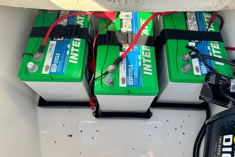 Slide: The Image of Three deep cycle batteries in a 2021 Regulator 26XO boat compartment. - 18