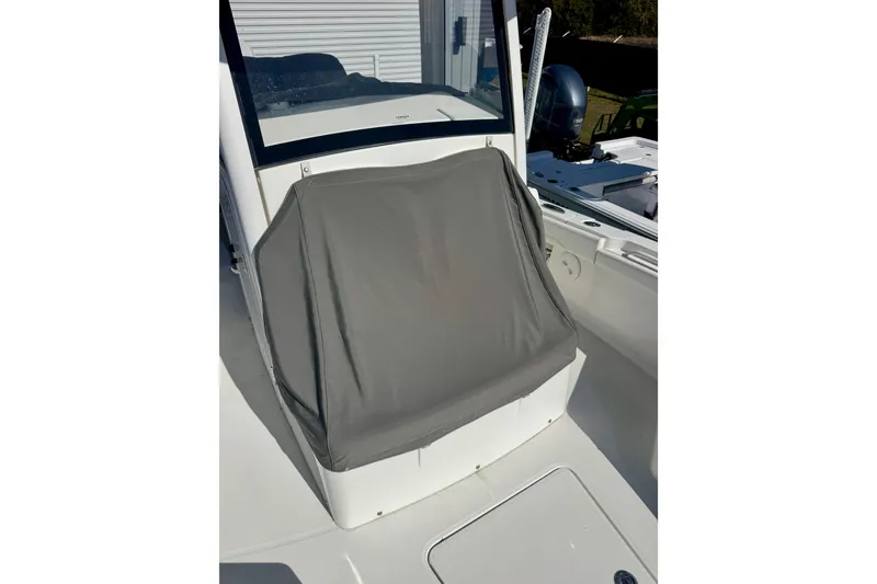 Slide: The Image of 2021 Regulator 26XO boat seat with protective cover, showcasing sleek design and functionality. - 21