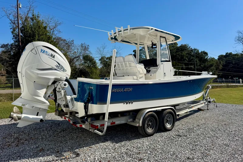 Slide: The Image of 2021 Regulator 26XO boat with Yamaha engine on trailer, parked outdoors. - 3