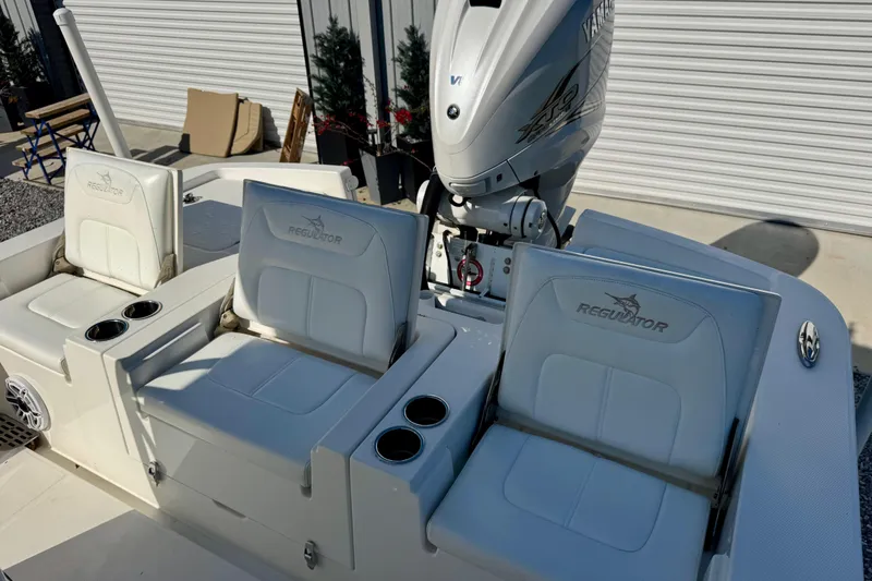 Slide: The Image of 2021 Regulator 26XO boat seats and Yamaha engine in a sunny outdoor setting. - 8