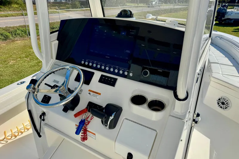 Slide: The Image of 2021 Regulator 26XO boat console with steering wheel, controls, and navigation display. - 9
