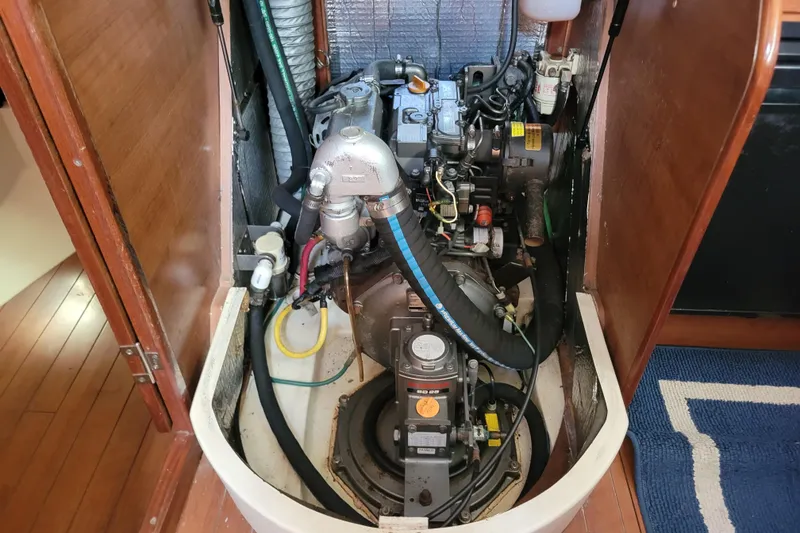 Slide: The Image of Engine compartment of a 2013 Hunter 33 sailboat, showcasing mechanical components. - 11