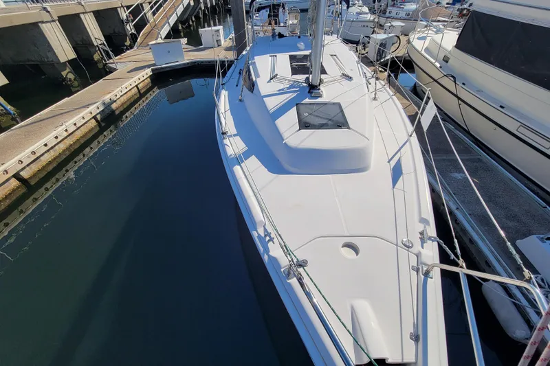 Slide: The Image of 2013 Hunter 33 sailboat docked at marina, top view of deck and surroundings. - 14