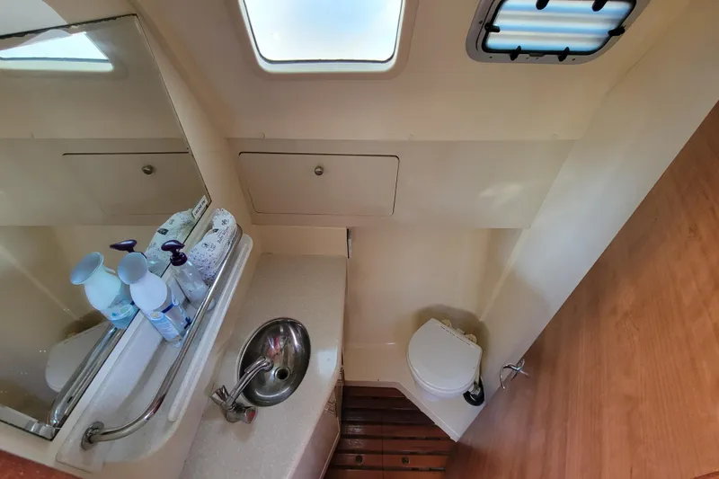 Slide: The Image of Compact bathroom in 2013 Hunter 33 yacht with sink, toilet, and storage. - 7