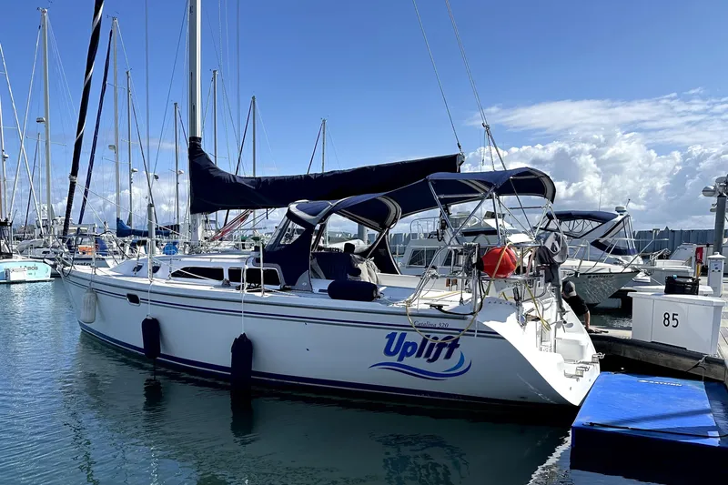 The Image of Catalina 320 Sloop 2005 sailboat docked at marina under clear blue sky. - 0