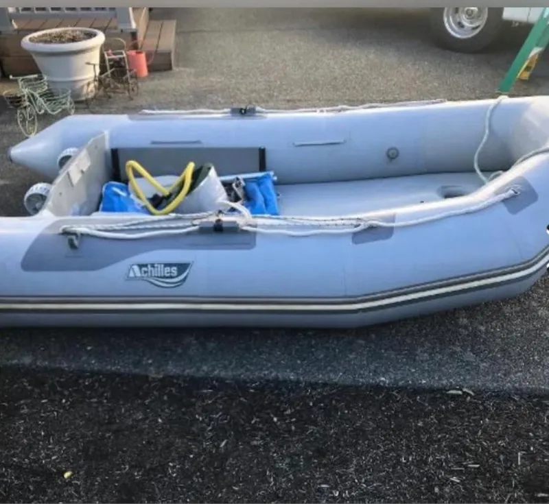 Slide: The Image of Inflatable Achilles boat on pavement, equipped with ropes and gear. - 5