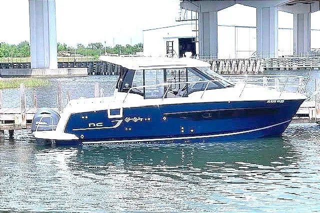 Slide: The Image of 2022 Jeanneau Merry Fisher 895 Offshore boat docked in a marina. - 1