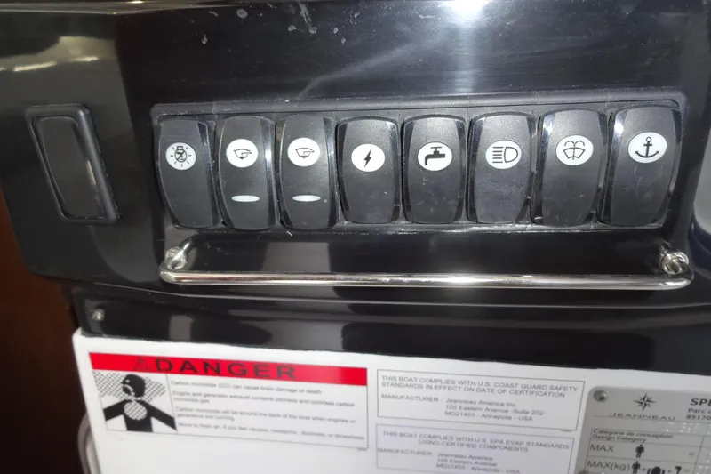 Slide: The Image of Control panel of 2022 Jeanneau Merry Fisher 895 Offshore boat with labeled switches. - 104