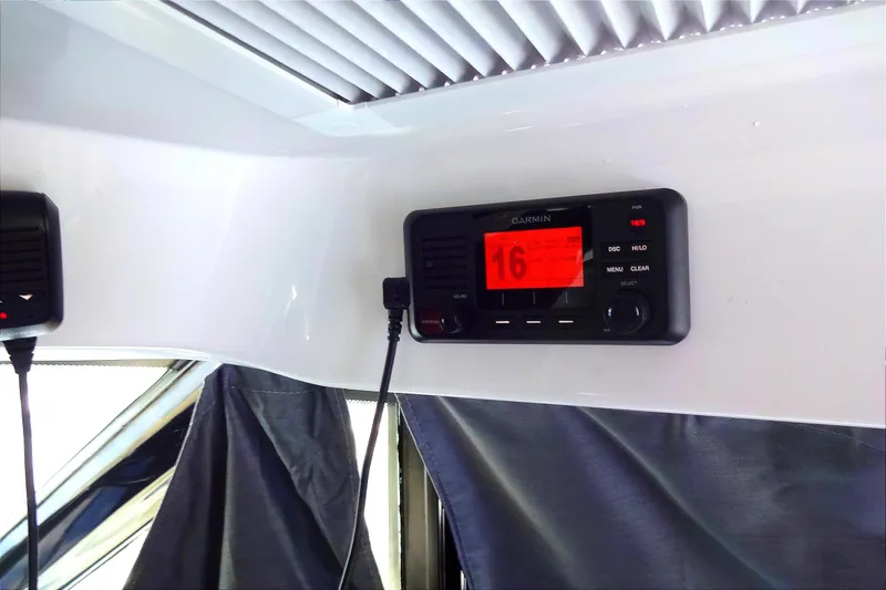 Slide: The Image of Garmin radio system inside 2022 Jeanneau Merry Fisher 895 Offshore boat cabin. - 108