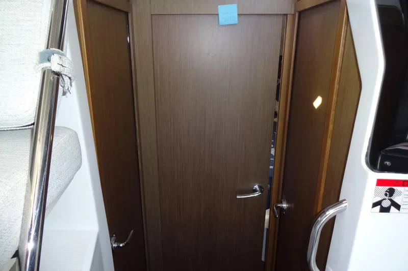 Slide: The Image of Interior view of 2022 Jeanneau Merry Fisher 895 Offshore, featuring wooden doors and modern design. - 110