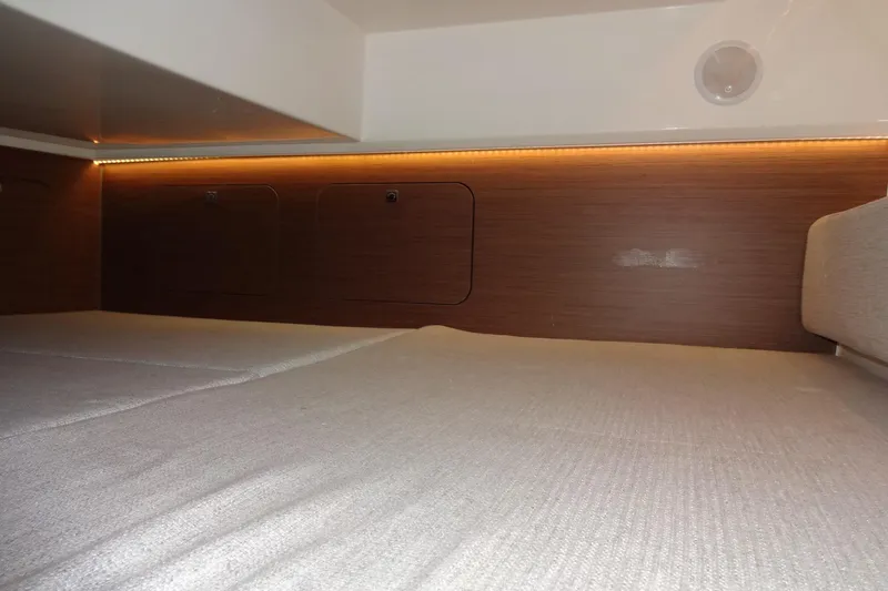 Slide: The Image of Interior cabin of 2022 Jeanneau Merry Fisher 895 Offshore, featuring cozy bedding and wood paneling. - 117