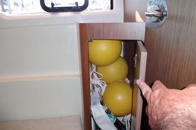 Slide: The Image of Storage compartment with yellow buoys on Jeanneau Merry Fisher 895 Offshore, 2022 model. - 120
