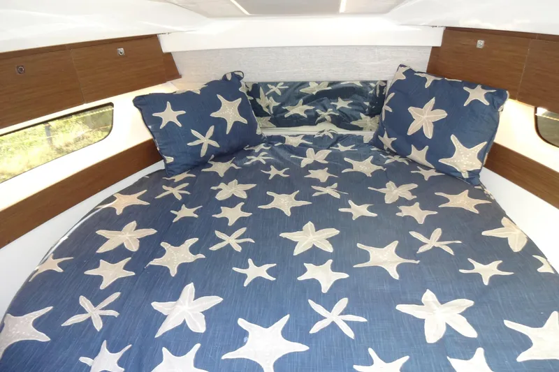 Slide: The Image of Cabin interior of 2022 Jeanneau Merry Fisher 895 Offshore with starfish bedding. - 122