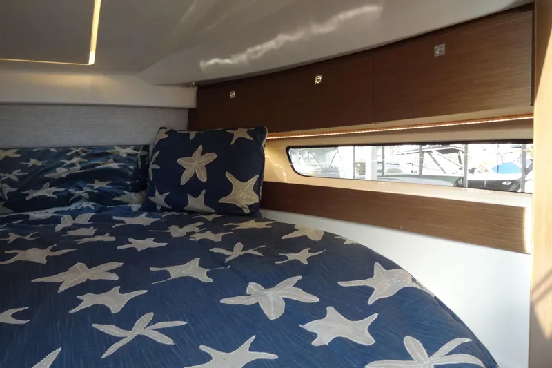 Slide: The Image of Interior cabin of 2022 Jeanneau Merry Fisher 895 Offshore with starfish bedding. - 127