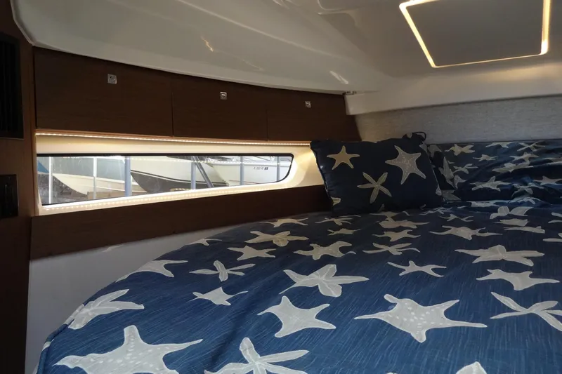 Slide: The Image of Cozy cabin interior of 2022 Jeanneau Merry Fisher 895 Offshore with starfish bedding. - 128