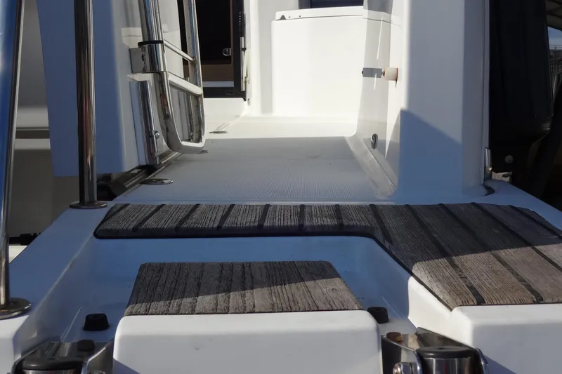 Slide: The Image of 2022 Jeanneau Merry Fisher 895 Offshore boat deck with wood accents and stainless steel railings. - 13