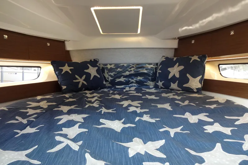 Slide: The Image of Cozy cabin interior of 2022 Jeanneau Merry Fisher 895 Offshore with starfish bedding. - 130