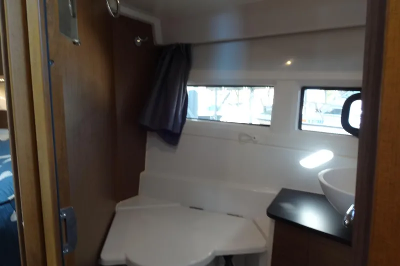 Slide: The Image of Interior of 2022 Jeanneau Merry Fisher 895 Offshore boat bathroom with sink and window. - 133