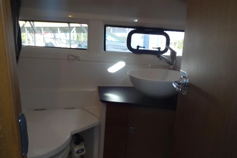 Slide: The Image of Interior of 2022 Jeanneau Merry Fisher 895 Offshore bathroom with sink and window. - 134
