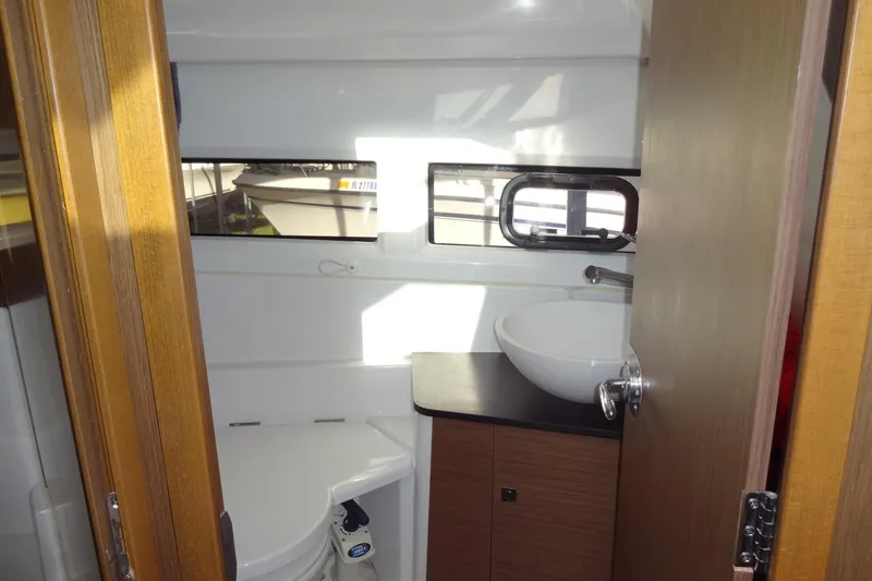 Slide: The Image of 2022 Jeanneau Merry Fisher 895 Offshore bathroom with sink and window. - 135