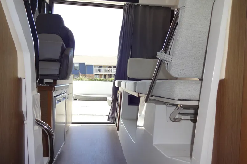 Slide: The Image of Interior view of 2022 Jeanneau Merry Fisher 895 Offshore boat, featuring seating and helm area. - 139