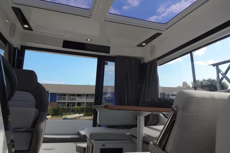 Slide: The Image of Interior of 2022 Jeanneau Merry Fisher 895 Offshore with panoramic windows and modern seating. - 140