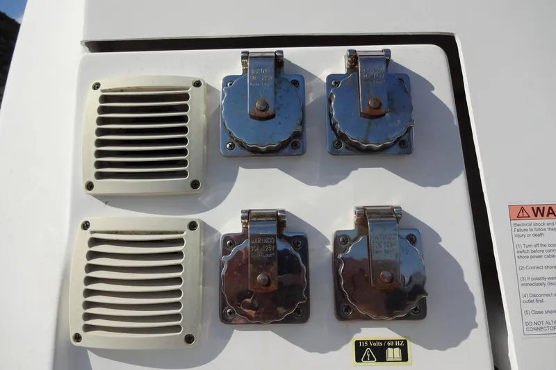 Slide: The Image of Electrical panel on 2022 Jeanneau Merry Fisher 895 Offshore boat with warning label. - 145