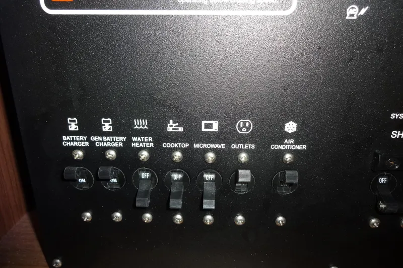 Slide: The Image of Control panel of 2022 Jeanneau Merry Fisher 895 Offshore with switches for various systems. - 150