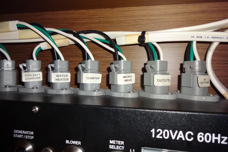 Slide: The Image of Electrical panel of 2022 Jeanneau Merry Fisher 895 Offshore boat, labeled switches and wiring. - 152