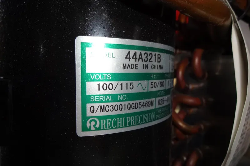 Slide: The Image of Label on a Rechi Precision component, model 44A321B, showing voltage and serial number details. - 159