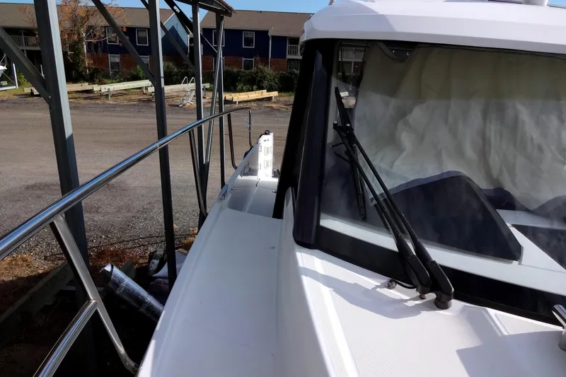 Slide: The Image of 2022 Jeanneau Merry Fisher 895 Offshore docked, showcasing sleek design and spacious deck. - 16