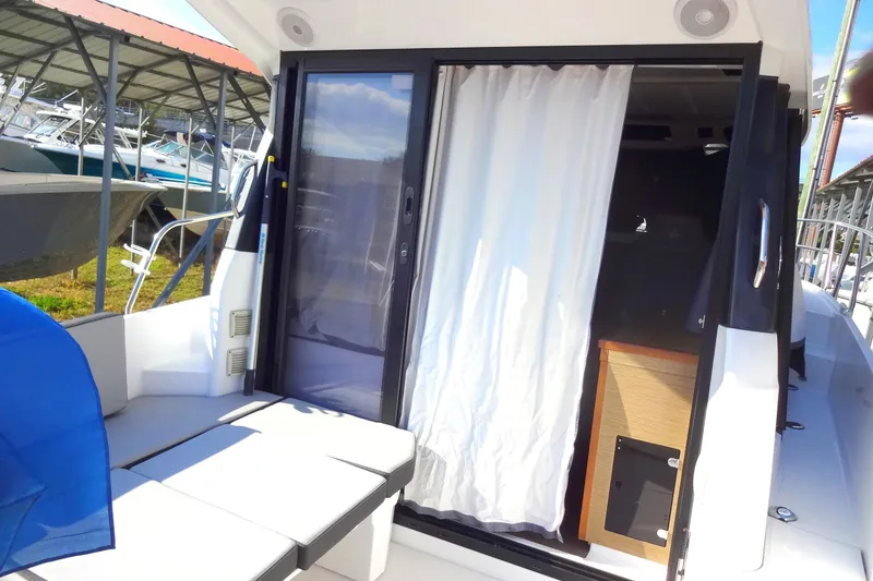 Slide: The Image of 2022 Jeanneau Merry Fisher 895 Offshore boat with sliding door and outdoor seating. - 23