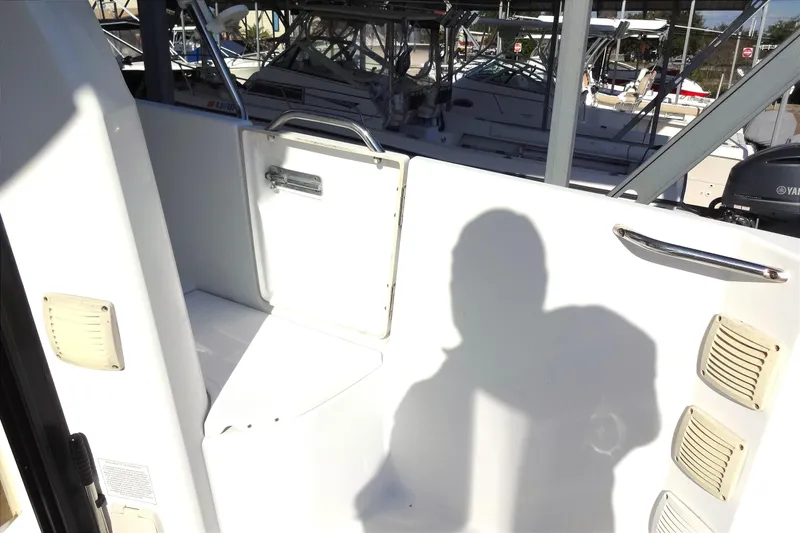 Slide: The Image of 2022 Jeanneau Merry Fisher 895 Offshore boat interior with shadow and docked vessels. - 24
